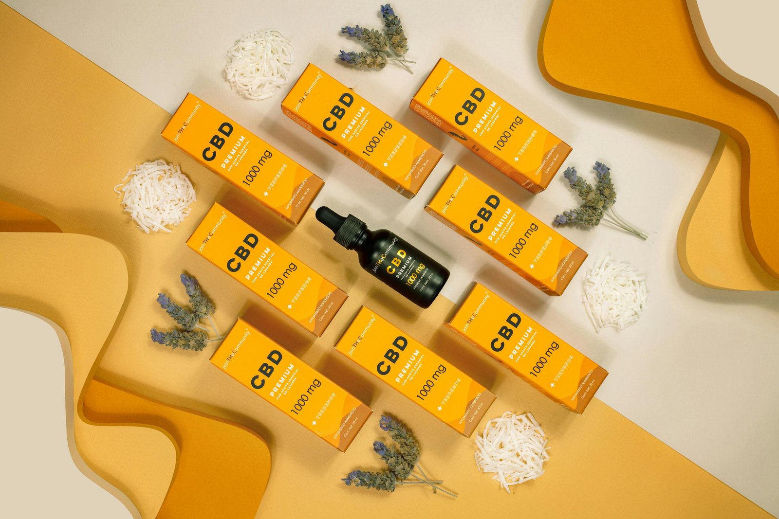 CBD oil dropper bottle with multiple orange premium 1000mg CBD boxes arranged on a yellow background